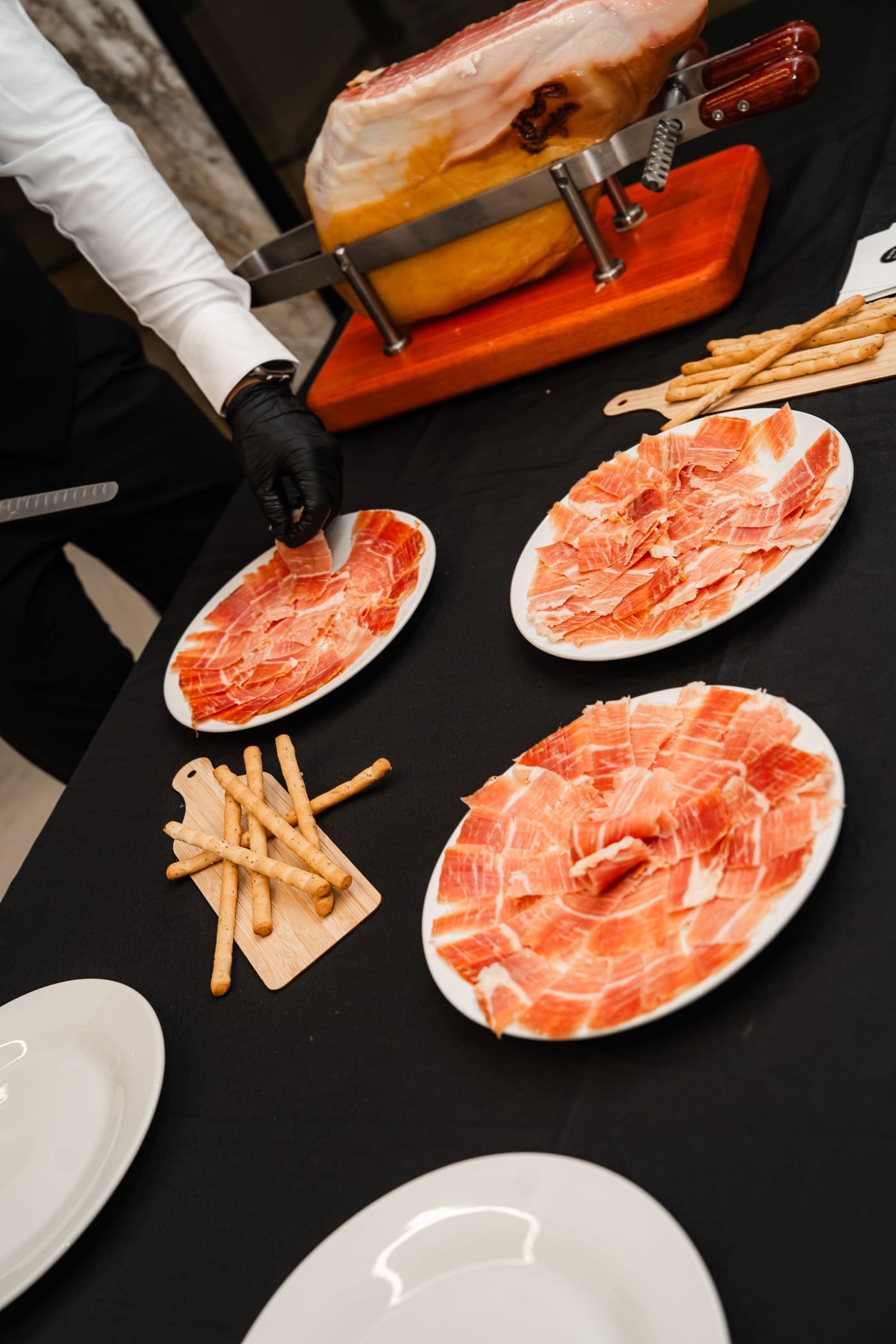 Iberico Sydney professional carving station with jamón on the jamonero and plated slices