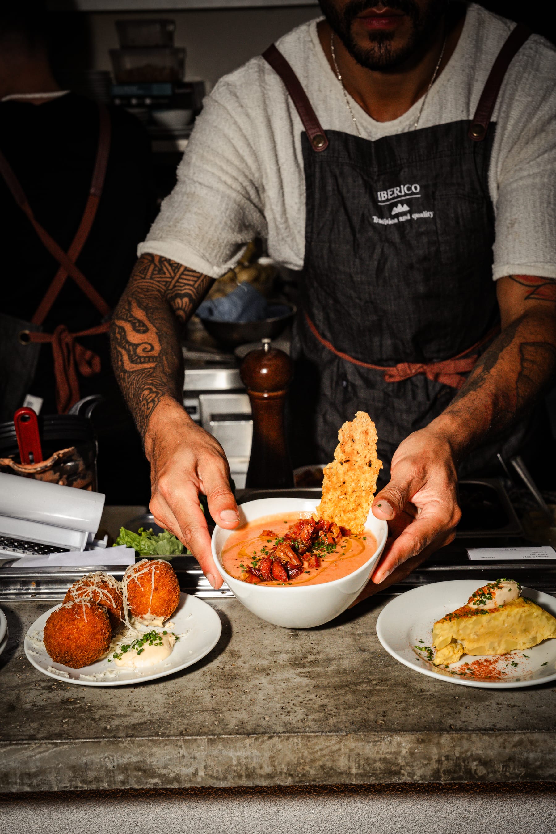 Chef plating Spanish dishes